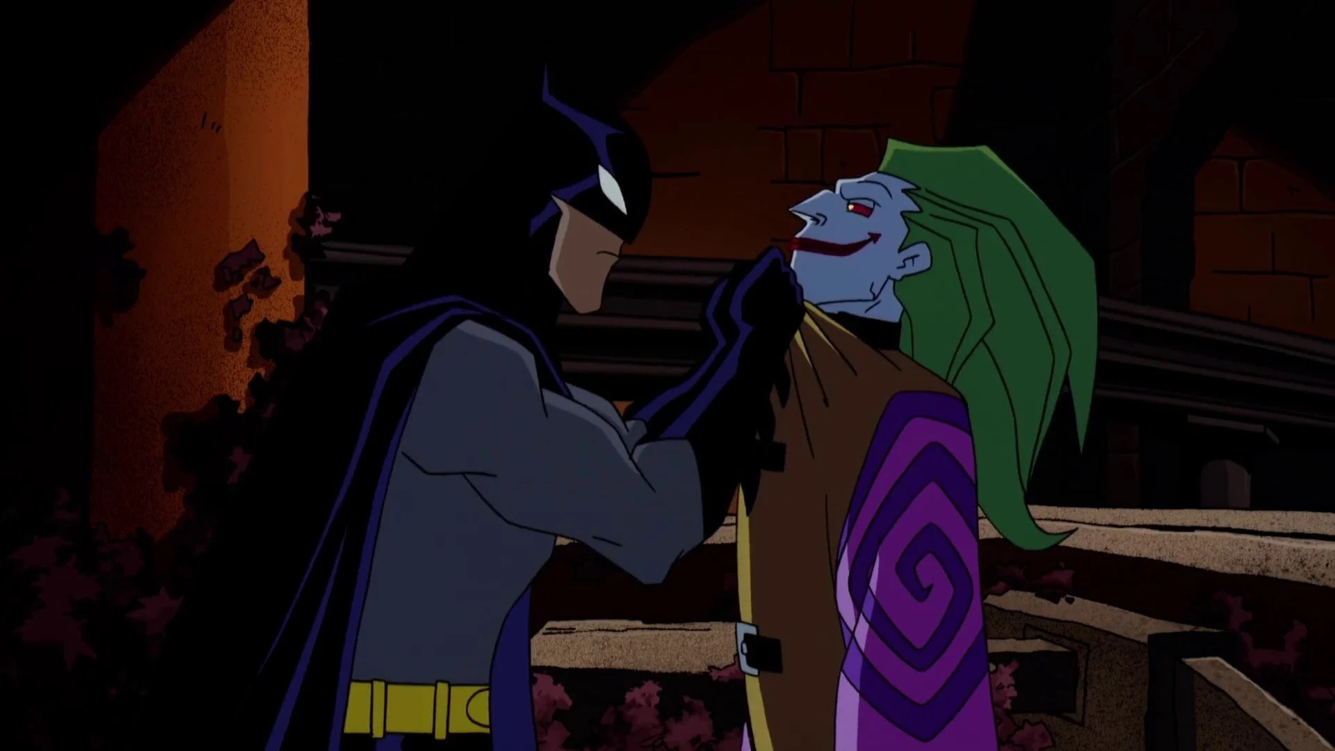 Cena do desenho The Batman com Batman segurando o Coringa pela camiseta. Enquanto Batman tem uma expressão séria, o Coringa tem um sorriso sereno no rosto.